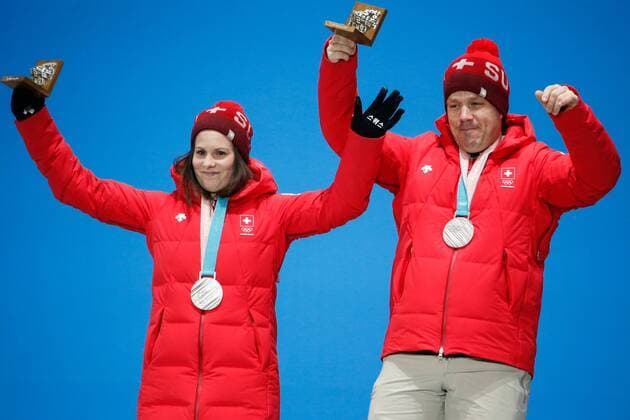 Curling mixed doubles silver medal winners Jenny Perret and Martin Rios of Switzerland celebrate on the podium at the medals ceremony for the 2018 Pyeongchang Winter Olympics at the Pyeongchang Medals Plaza in Pyeongchang, South Korea, on February 14, 2018.  OLY20180214125 MATTHEWxHEALEY