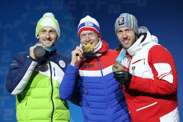 OLYMPICS - 2018 Winter Olympics PYEONGCHANG,SOUTH KOREA,16.FEB.18 - OLYMPICS,BIATHLON - Olympic Winter games Winterspiele Spiele Summer games PyeongChang 2018, Medals Plaza, 20km biathlon, men, award ceremony. Image shows Jakov Fak (SLO), Johannes Thingnes Boe (NOR) and Dominik Landertinger (AUT). GEPAxpictures xMathiasxMandl
