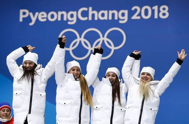 PYEONGCHANG, SOUTH KOREA - FEBRUARY 18, 2018: Bronze medalists, Olympic Athletes from Russia Natalia Nepryaeva, Yulia Belorukova, Anastasia Sedova, and Anna Nechaevskaya (L-R) cheer at a victory ceremony for the ladies cross-country skiing 4x5km relay race at the 2018 Winter Olympic Games Olympische Spiele Olympia OS at the Alpensia Cross-Country Skiing Centre. Valery Sharifulin TASS  TS0747C0