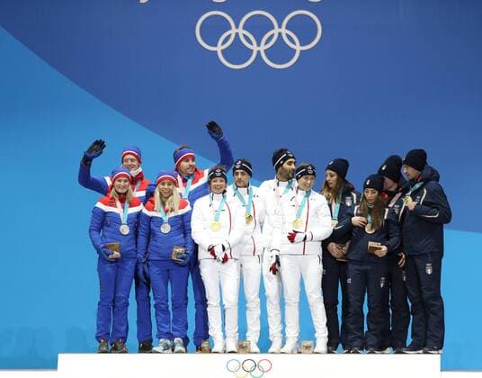 (180221) -- PYEONGCHANG, Feb. 21, 2018 -- Champion team France (C), second-placed team Norway (L) and third-placed team Italy react during medal ceremony of 2x6km women + 2x7.5km men mixed relay of biathlon at 2018 PyeongChang Winter Olympic Games Olympische Spiele Olympia OS at Medal Plaza, PyeongChang, South Korea, Feb. 21, 2018. ) (SP)OLY-SOUTH KOREA-PYEONGCHANG-BIATHLON-MIXED RELAY-MEDAL CEREMONY LixGang 