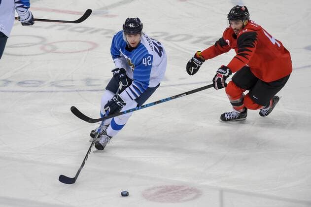 PYEONGCHANG, South Korea - FEBRUARY 21: Finland men s hockey defender Heiskanen Miro (42) looks to pass as Canada men s hockey forward Maxim Lapierre (40) defends during the men s hockey semi final game between Canada and Finland during the 2018 Winter Olympic Games Olympische Spiele Olympia OS at the Gangneung Hockey Center on February 21, 2018 in PyeongChang, South Korea. Canada advances to the gold medal game with 1-0 victory. (Photo by Ken Murray Icon Sportswire) OLYMPICS: FEB 21 PyeongChang - Day 14 Icon18022114036 EDITORIAL USE ONLY