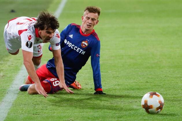 MOSCOW, RUSSIA - FEBRUARY 21, 2018: Crvena Zvezda Belgradeâ€™s Filip Stojkovic (L) and CSKA Moscow s Konstantin Kuchayev in their 2017-2018 UEFA Europa League Round of 32 second leg football match at VEB Arena in Moscow. Mikhail Metzel TASS  TS0751FD