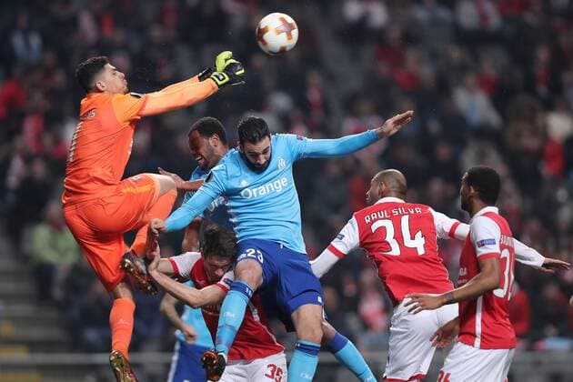 February 22, 2018 - Lisbon, Braga, Portugal - Braga s Brazilian goalkeeper Matheus Magalhaes (R) defends the ball with Marseille s French defender Adil Rami nearby, during the UEFA Europa League, match between SC Braga and Olympique Marseille, at Municipal de Braga Stadium in Braga on February 22, 2018, Portugal. Sporting Braga v Marseille - UEFA Europa League  - ZUMAn230 20180222_zaa_n230_629 Copyright: xDpix