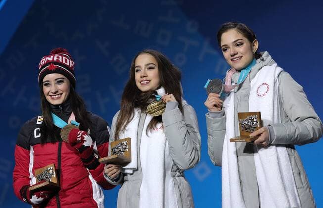 PYEONGCHANG, SOUTH KOREA â€“ FEBRUARY 23, 2018: Silver medallist Evgenia Medvedeva, Olympic Athlete from Russia, gold medallist Alina Zagitova, Olympic Athlete from Russia, and bronze medallist Kaetlyn Osmond of Canada, from right, pose at a victory ceremony for the ladies Figure skating Eiskunstlauf event at the 2018 Winter Olympic Games Olympische Spiele Olympia OS Sergei Bobylev TASS  TS075706