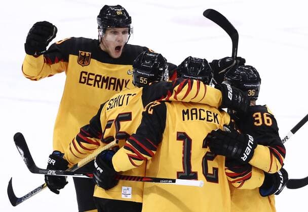 GANGNEUNG, SOUTH KOREA â€“ FEBRUARY 23, 2018: Germany s David Wolf, Feliz Schutz, Brooks Macek, and Yannic Seidenberg (L-R) celebrate scoring in their men s semifinal Ice hockey Eishockey match against Canada during the 2018 Winter Olympic Games Olympische Spiele Olympia OS at the Gangneung Hockey Centre. Valery Sharifulin TASS  TS07575D