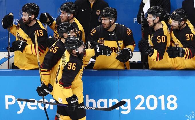 GANGNEUNG, SOUTH KOREA â€“ FEBRUARY 23, 2018: Germany s Feliz Schutz and Yannic Seidenberg (L-R) celebrate scoring with their teammates in their men s semifinal Ice hockey Eishockey match against Canada during the 2018 Winter Olympic Games Olympische Spiele Olympia OS at the Gangneung Hockey Centre. Valery Sharifulin TASS  TS075760