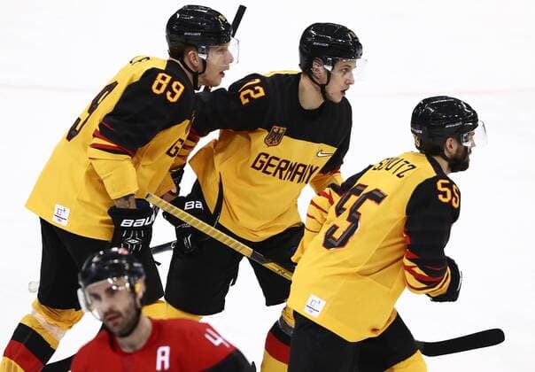 GANGNEUNG, SOUTH KOREA â€“ FEBRUARY 23, 2018: Germany s David Wolf, Dominik Kahun, and Feliz Schutz (L-R) celebrate scoring in their men s semifinal Ice hockey Eishockey match against Canada during the 2018 Winter Olympic Games Olympische Spiele Olympia OS at the Gangneung Hockey Centre. Valery Sharifulin TASS  TS075766