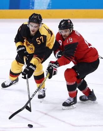 GANGNEUNG, SOUTH KOREA â€“ FEBRUARY 23, 2018: Germany s Marcel Goc (L) and Canada s Andrew Ebbett in action in their men s semifinal Ice hockey Eishockey match during the 2018 Winter Olympic Games Olympische Spiele Olympia OS at the Gangneung Hockey Centre. Valery Sharifulin TASS  TS07578C