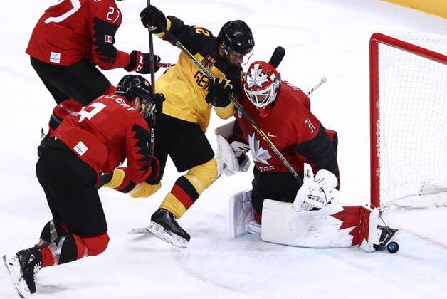 GANGNEUNG, SOUTH KOREA â€“ FEBRUARY 23, 2018: Canada s Karl Stollery (L), goaltender Kevin Poulin (R) defend against Germany s Yasin Ehliz (C) in their men s semifinal Ice hockey Eishockey match during the 2018 Winter Olympic Games Olympische Spiele Olympia OS at the Gangneung Hockey Centre. Valery Sharifulin TASS  TS075796