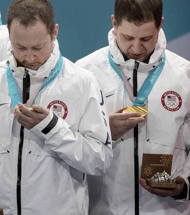 February 24, 2018 - Pyeongchang, KOR - Tyler George and John Shuster of Team USA look at gold medals after a 10-7 win against Sweden on Saturday, Feb. 24, 2018, at the Pyeongchang Winter Olympics Gangneung Curling Centre. John Shuster leads Team USA to Olympic curling gold - ZUMAm67_ 20180224_zaf_m67_003 Copyright: xCarlosxGonzalezx