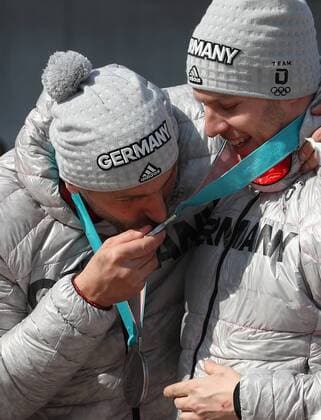 (180225) -- PYEONGCHANG, Feb. 25, 2018 -- An athlete of Germany kisses his teammate s silver medal after the 4-man event of bobsleigh at the 2018 PyeongChang Winter Olympic Games Olympische Spiele Olympia OS at Olympic Sliding Centre, PyeongChang, South Korea, Feb. 25, 2018. ) (SP)OLY-SOUTH KOREA-PYEONGCHANG-BOBSLEIGH-4-MAN BaixXuefei 
