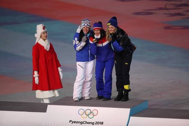 OLYMPICS - 2018 Winter Olympics PYEONGCHANG,SOUTH KOREA,25.FEB.18 - OLYMPICS - Olympic Winter games Winterspiele Spiele Summer games PyeongChang 2018, official closing ceremony. Image shows Krista Parmakoski (FIN), Marit Bjoergen (NOR) and Stina Nilsson (SWE). Keywords: award ceremony cross country, 30km, ladies. GEPAxpictures xChristianxWalgram