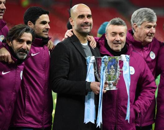 Arsenal v Manchester City Carabao Cup Final Josep Guardiola manager of Manchester City posses with the trophy and his coaching team at the end of the the Carabao Cup Final match at Wembley Stadium, London Content Not Available For UK Newspapers Copyright: xSimonxDaelx FIL-11419-0100