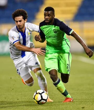 (180306) -- DOHA, March 6, 2018 -- Ahmed Al Aaeldin (L) of Al Gharafa vies with Mansour Al-Harbi of Al Ahli during the AFC Champions League Group A soccer match between Qatar s Al-Gharafa and Saudi Arabia s Al Ahli at Thani bin Jassim Stadium in Doha, Capital of Qatar, March 5, 2018. The match ended with a 1-1 draw. ) (SP)QATAR-DOHA-SOCCER-AFC-AL GHARAFA VS AL AHLI Nikku 