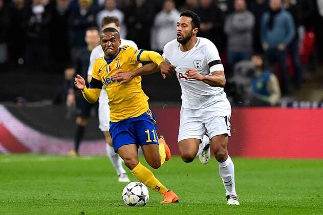 March 7, 2018 - London, United Kingdom - Mousa Dembl of Tottenham is challenged by Douglas Costa of Juventus during the UEFA Champions League match between Tottenham Hotspur and Juventus at Wembley Stadium, London, England on 7 March 2018. Tottenham v Juventus - UEFA Champions League  - ZUMAn230 20180307_zaa_n230_199 Copyright: xGiuseppexMaffiax