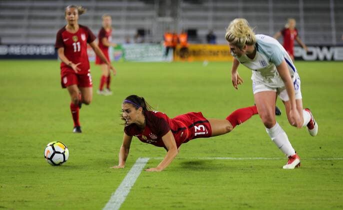 March 7, 2018 - Orlando, Florida, USA - Unites States forward Alex Morgan (13) falls as she looses control after battling with England defender Millie Bright (6) during the first half of the SheBelieves Cup women s soccer match between the USA Women s national team Nationalteam and the English Women s National Team at the Orlando City Stadium in Orlando, Florida. Soccer 2018: SheBelieves Cup - USA vs England MAR 07 - ZUMAh333 20180307_zap_h333_011 Copyright: xMarioxHoubenx