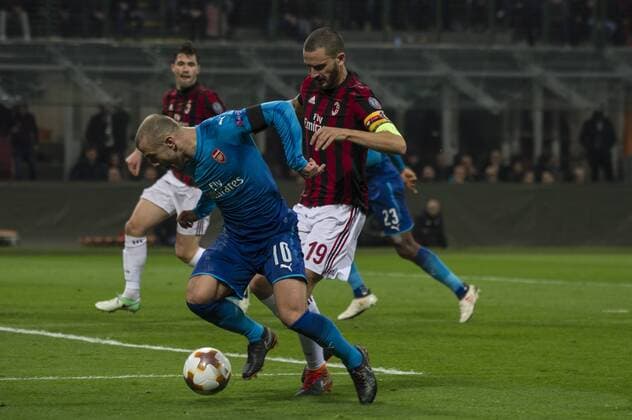 8th March 2018, San Siro, Milan, Italy; UEFA Europa League football, round of 16, 1st leg, AC Milan versus Arsenal FC; Jack Wilshere of Arsenal tackled from behind by Leonardo Bonucco of AC Milan  ActionPlus11999354