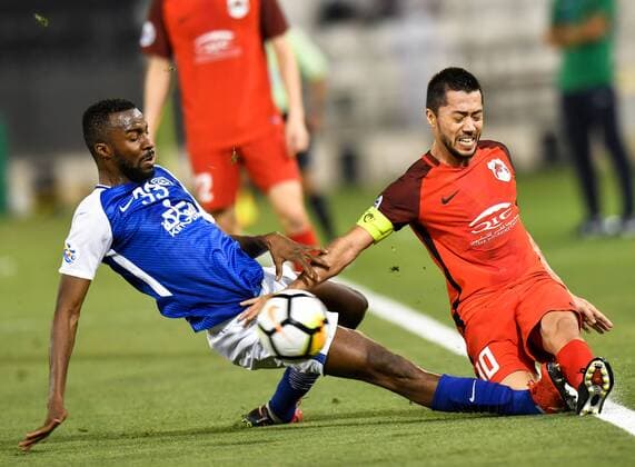 (180313) -- DOHA, March 13, 2018 -- Osama Hawsawi (L) of Al-Hilal FC vies with Rodrigo Tabata of Al-Rayyan during the AFC Champions League Group D soccer match between Qatar s Al-Rayyan and Saudi Arabia s Al-Hilal FC at Jassim Bin Hamad Stadium in Doha, capital of Qatar, March 12, 2018. Qatar s Al-Rayyan won 2-1. ) (SP)QATAR-DOHA-SOCCER-AFC CHAMPIONS-GROUP D Nikku 
