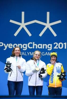 PYEONGCHANG, SOUTH KOREA - MARCH 13, 2018: Second- and first-placed neutral Paralympic athletes (NPA) from Russia Anna Milenina, Yekaterina Rumyantseva, and third-placed Liudmyla Liashenko (L-R) of Ukraine pose at a ceremony to award the women s 10km standing biathlon race winners at the 2018 Winter Paralympic Games. Vladimir Smirnov TASS  TS07770F