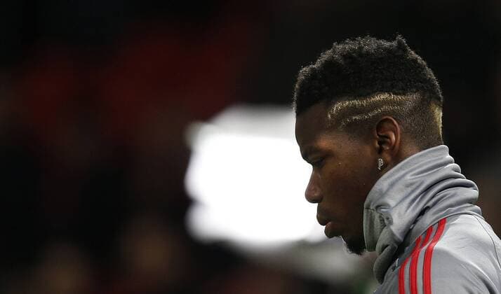 Paul Pogba of Manchester United ManU saws his double P earrings as he warms up before the Champions League Round of 16 match at Old Trafford Stadium, Manchester. Picture date: March 13th 2018. Picture credit should read: Andrew Yates Sportimage EDITORIAL USE ONLY. No use with unauthorised audio, video, data, fixture lists, club league logos or live services. Online in-match use limited to 120 images, no video emulation. No use in betting, games or single club league player publications.