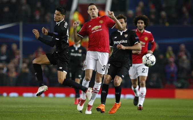 Nemanja Matic of Manchester United ManU plays the ball away from Joaquin Correa of Sevilla (left) and Franco Vazquez of Sevilla during the Champions League Round of 16 match at Old Trafford Stadium, Manchester. Picture date: March 13th 2018. Picture credit should read: Andrew Yates Sportimage EDITORIAL USE ONLY. No use with unauthorised audio, video, data, fixture lists, club league logos or live services. Online in-match use limited to 120 images, no video emulation. No use in betting, games or single club league player publications.