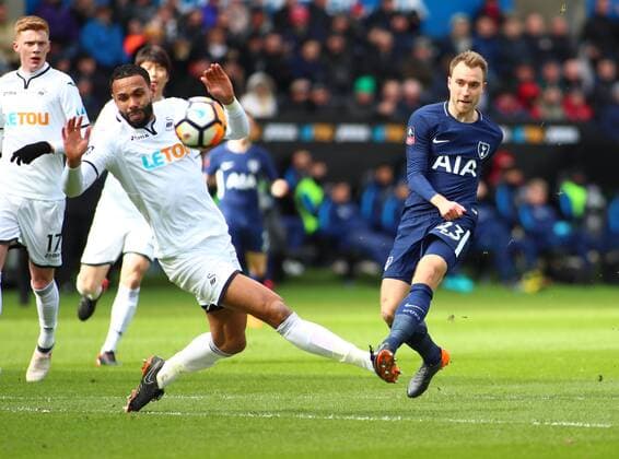17th March 2018, Liberty Stadium, Swansea, Wales; FA Cup football, quarter-final, Swansea City versus Tottenham Hotspur Christian Eriksen of Tottenham Hotspur curls his shot around Kyle Bartley of Swansea City to find the top corner of the net scoring his sides 1st goal of the game in the 12th minute  ActionPlus12002277