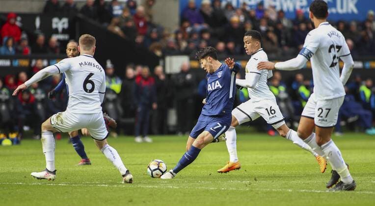 17th March 2018, Liberty Stadium, Swansea, Wales; FA Cup football, quarter-final, Swansea City versus Tottenham Hotspur; Son Heung-Min of Tottenham Hotspur attempts a shot whilst pressured by the Swansea City defence  ActionPlus12002295
