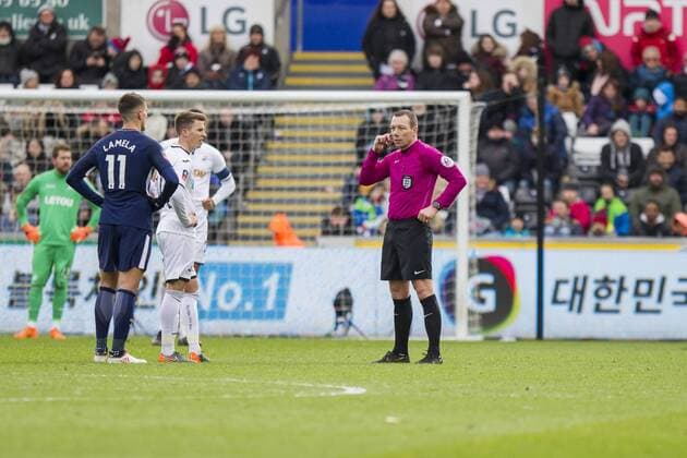 Referee Kevin Friend waits on a video decision during the FA Cup Quarter Final match between Swansea City and Tottenham Hotspur at the Liberty Stadium, Swansea, Wales on 17 March 2018. Copyright: xMarkxxHawkinsx PMI-1893-0027