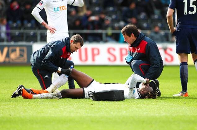 17th March 2018, Liberty Stadium, Swansea, Wales; FA Cup football, quarter-final, Swansea City versus Tottenham Hotspur; Tammy Abraham of Swansea City receives treatment for an injury to his right knee in the 2nd half  ActionPlus12002342