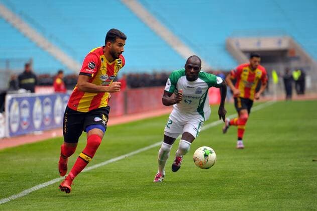 Haithem Jouini(14) and Onyango Joash(12) during the match Esperance Sportive de Tunis who validated his ticket to the group phase of the African Champions League after a short victory of (1-0) face Gor Mahia Kenyan club in the second leg of the final of the competition sixteenths played at Rades stadium. African Champions League:EST vs Gor Mahia. 