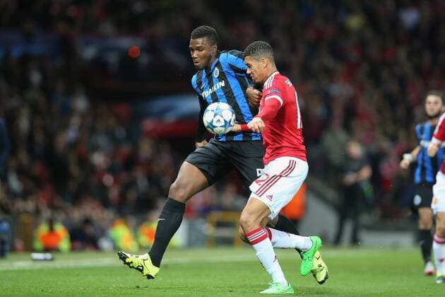 - MANCHESTER, UNITED KINGDOM: Club s Obbi Oulare and Manchester s Chris Smalling fight for the ball during a soccer game between British club Manchester United ManU FC and Belgian team Club Brugge KV in Manchester, United Kingdom, Tuesday 18 August 2015, the first leg of the play-offs for the UEFA Champions League competition. BRUNOxFAHY x84381921x