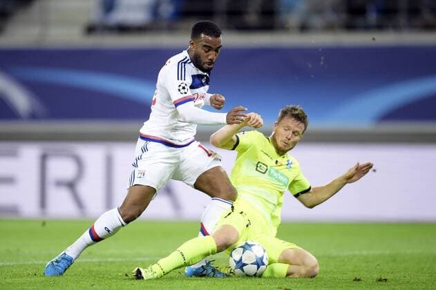 - GENT, BELGIUM: Lyon s Alexandre Lacazette and Gent s Lasse Nielsen fight for the ball during the first game in the group stage of the Uefa Champions League competition, in group H, between Belgian first league soccer team KAA Gent and Olympique Lyon, in Gent, Wednesday 16 September 2015. YORICKxJANSENS x85280474x