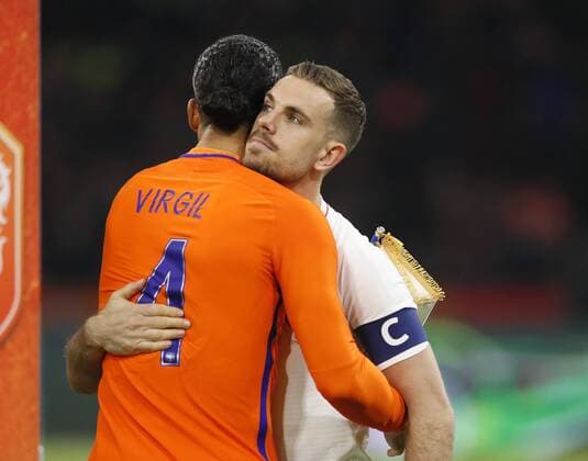 Netherland s Virgil Van Djik hugs England s Jordan Henderson during the International Friendly Länderspiel match at the Amsterdam Arena, Amsterdam. Picture date: March 23rd 2018. Picture credit should read: David Klein Sportimage EDITORIAL USE ONLY. No use with unauthorised audio, video, data, fixture lists, club league logos or live services. Online in-match use limited to 120 images, no video emulation. No use in betting, games or single club league player publications.