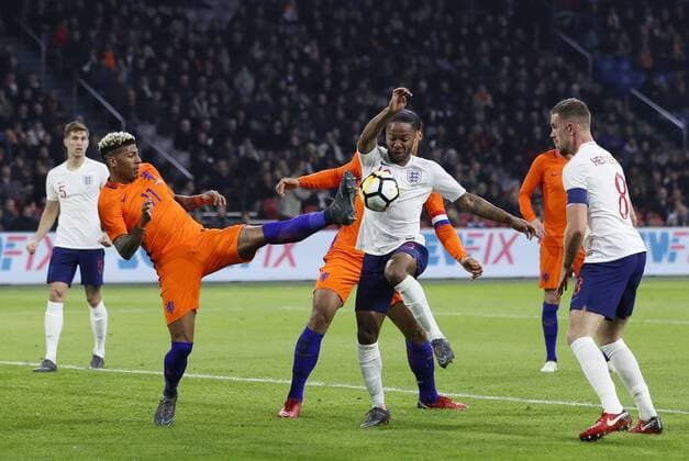 Netherland s Patrick Van Aanholt tussles with England s Raheem Sterling and Jordan Henderson during the International Friendly Länderspiel match at the Amsterdam Arena, Amsterdam. Picture date: March 23rd 2018. Picture credit should read: David Klein Sportimage EDITORIAL USE ONLY. No use with unauthorised audio, video, data, fixture lists, club league logos or live services. Online in-match use limited to 120 images, no video emulation. No use in betting, games or single club league player publications.