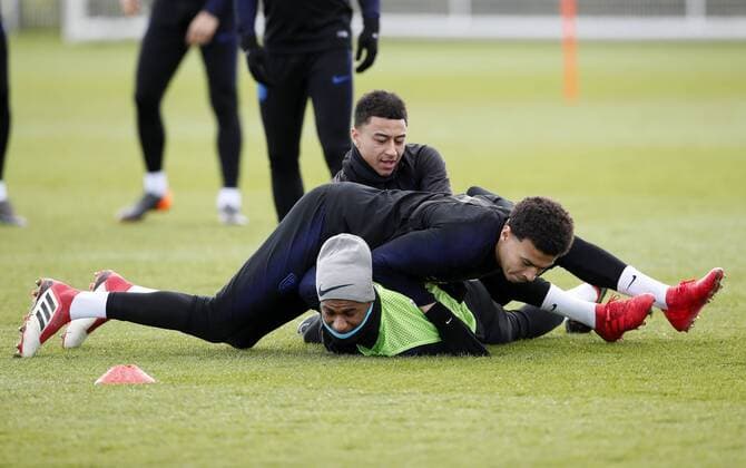 England s Jesse Lingard and Dele Alli bundle Marcus Rashford during training at the Tottenham Hotspur Training Centre, London. Picture date: March 26th 2018. Picture credit should read: David Klein Sportimage EDITORIAL USE ONLY. No use with unauthorised audio, video, data, fixture lists, club league logos or live services. Online in-match use limited to 120 images, no video emulation. No use in betting, games or single club league player publications.