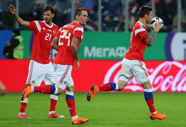 ST PETERSBURG, RUSSIA - MARCH 27, 2018: Russia s Alexander Yerokhin, Anton Zabolotny and Fyodor Smolov (L-R) celebrate scoring in a friendly football match against France at Saint Petersburg Stadium. Peter Kovalev TASS  TS079A21