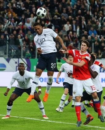 ST PETERSBURG, RUSSIA - MARCH 27, 2018: France s Paul Pogba, Anthony Martial and Russia s Alexei Miranchuk (L-R) fight for the ball in their friendly football match at Saint Petersburg Stadium. The French team won the game 3-1. Peter Kovalev TASS  TS079A30