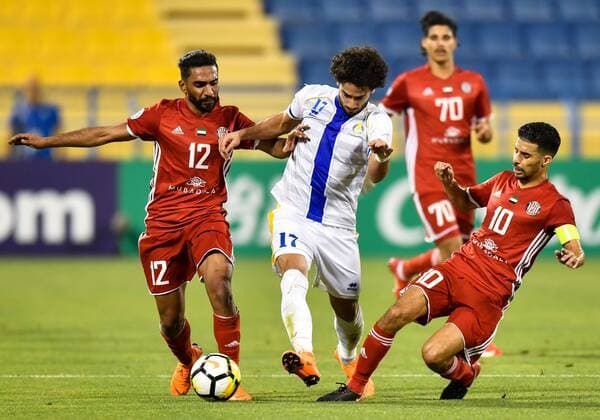 (180404) -- DOHA, April 4, 2018 -- Salim Rashid (L) and Mbark Boussoufa (R) of Al Jazira FSC vie for the ball with Ahmed Al Aaeldin (C) of Al Gharafa during the AFC Champions League Group A soccer match between Qatar s Al Gharafa and Al Jazira FSC of the United Arab Emirates (UAE) at Thani Bin Jassim Stadium in Doha, capital of Qatar, April 3, 2018. Al Jazira FSC won 3-2. ) (SP)QATAR-DOHA-SOCCER-AFC CHAMPIONS LEAGUE Nikku 