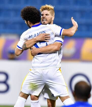 (180404) -- DOHA, April 4, 2018 -- Ahmed Al Aaeldin (L) of Al Gharafa celebrates with teammate Diogo Amado after scoring the first goal against Al Jazira FSC during the AFC Champions League Group A soccer match between Qatar s Al Gharafa and Al Jazira FSC of the United Arab Emirates (UAE) at Thani Bin Jassim Stadium in Doha, capital of Qatar, April 3, 2018. Al Jazira FSC won 3-2. ) (SP)QATAR-DOHA-SOCCER-AFC CHAMPIONS LEAGUE Nikku 