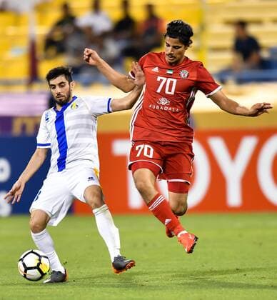 (180404) -- DOHA, April 4, 2018 -- Yousuf Muftah (L) of Al Gharafa vies with Ahmed Al Hashmi of Al Jazira FSC during the AFC Champions League Group A soccer match between Qatar s Al Gharafa and Al Jazira FSC of the United Arab Emirates (UAE) at Thani Bin Jassim Stadium in Doha, capital of Qatar, April 3, 2018. Al Jazira FSC won 3-2. ) (SP)QATAR-DOHA-SOCCER-AFC CHAMPIONS LEAGUE Nikku 