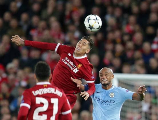 4th April 2018, Anfield, Liverpool, England; UEFA Champions League football, quarter final 1st leg, Liverpool versus Manchester City; Roberto Firmino of Liverpool beats Vincent Kompany of Manchester City in the air  ActionPlus12008375