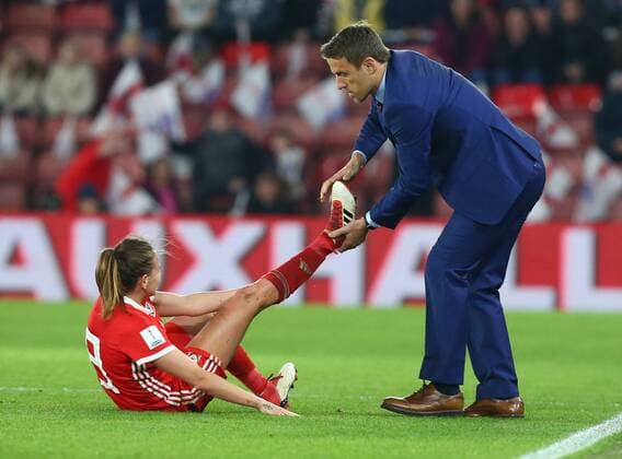 April 6, 2018 - Southampton, England, United Kingdom - England women s head coach Phil Neville helps Kayleigh Green of Wales Women with cramp..during 2019 FIFA Women s World Cup Group 1 qualifier match between England and Wales at St.Mary s, Southampton FC Southampton , England on 06 April 2018. England v Wales - Women s World Cup Qualifier  - ZUMAn230 20180406_zaa_n230_764 Copyright: xKieranxGalvinx