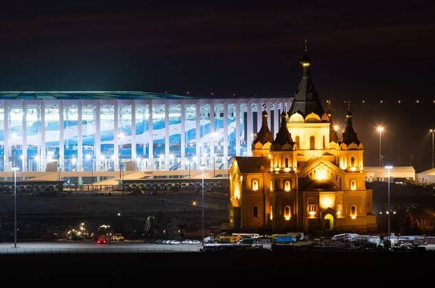 NIZHNY NOVGOROD, RUSSIA - APRIL 14, 2018: A view of the Alexander Nevsky Cathedral and the Nizhny Novgorod Stadium, a venue for 2018 FIFA World Cup WM Weltmeisterschaft Fussball matches. Stanislav Krasilnikov TASS  TS07BEC4