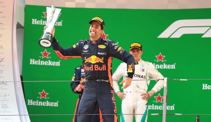 Australian F1 driver Daniel Ricciardo of Red Bull Racing holds up his trophy to celebrate on the podium after winning the 2018 Formula One Chinese Grand Prix at the Shanghai International Circuit in Shanghai, China, 15 April 2018. Daniel Ricciardo charged from sixth to score a stunning first win of the 2018 Formula 1 season as Max Verstappen and Sebastian Vettel collided in a wild Chinese Grand Prix. Bottas and Vettel were locked in their own battle for the win until Ricciardo and Verstappen pitted again for fresh, soft tyres during a safety car period just after the halfway mark as their rivals stayed on mediums. Ricciardo then overtook his team-mate, Lewis Hamilton and Vettel in quick succession before executing a stunning pass on Bottas into the tight Turn 6 right-hander for the victory. Daniel Ricciardo storms to Chinese Grand Prix victory for Red Bull 