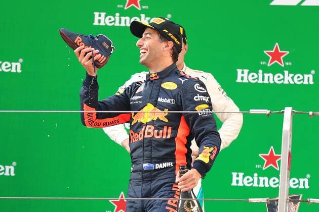 Australian F1 driver Daniel Ricciardo of Red Bull Racing drinks champagne out of his shoe on the podium after winning the 2018 Formula One Chinese Grand Prix at the Shanghai International Circuit in Shanghai, China, 15 April 2018. Daniel Ricciardo charged from sixth to score a stunning first win of the 2018 Formula 1 season as Max Verstappen and Sebastian Vettel collided in a wild Chinese Grand Prix. Bottas and Vettel were locked in their own battle for the win until Ricciardo and Verstappen pitted again for fresh, soft tyres during a safety car period just after the halfway mark as their rivals stayed on mediums. Ricciardo then overtook his team-mate, Lewis Hamilton and Vettel in quick succession before executing a stunning pass on Bottas into the tight Turn 6 right-hander for the victory. Daniel Ricciardo storms to Chinese Grand Prix victory for Red Bull 