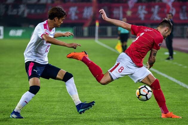 Serbian football player Nemanja Gudelj, right, of China s Guangzhou Evergrande Taobao FC, challenges Tatsuya Yamashita of Japan s Cerezo Osaka FC in their Group G match during the 2018 AFC Champions League in Guangzhou city, south China s Guangdong province, 17 April 2018. Brazilian striker Alan Carvalho scored twice in the second half to help Guangzhou Evergrande beat the visiting side Cerezo Osaka from Japan 3-1 in a Group G game, final round of the AFC Champions League group stage on Tuesday night. After this game, Guangzhou Evergrande remained unbeaten in this group, earning 12 points and place the first to progress to the knock-out stage of the AFC Champions League, while Buriram United from Thailand managed a 1-0 win over home team Jeju United from South Korea and secured another place in the knock-out stage. Huang Bowen broke the deadlock for Guangzhou Evergrande early in the fifth minute, as the 30-year-old midfielder received the pass from Li Xuepeng, got away from defenders in the penalty area and scored the opening goal. Guangzhou Evergrande beat Cerezo Osaka 3-1 in AFC Champions League  20180417_72016
