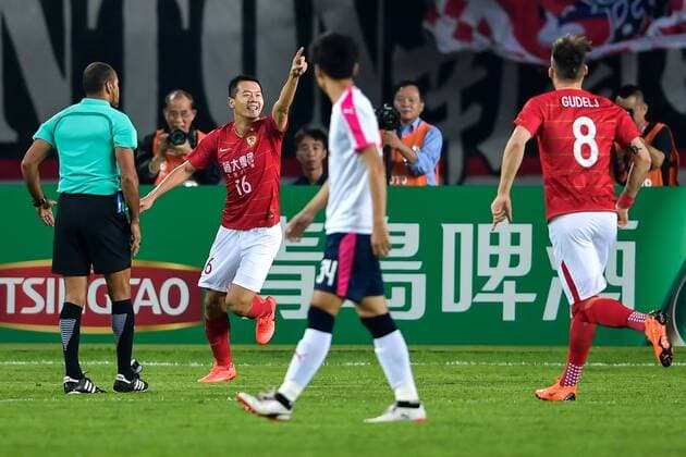 Huang Bowen, second left, of China s Guangzhou Evergrande Taobao FC, celebrates after scoring against Japan s Cerezo Osaka FC in their Group G match during the 2018 AFC Champions League in Guangzhou city, south China s Guangdong province, 17 April 2018. Brazilian striker Alan Carvalho scored twice in the second half to help Guangzhou Evergrande beat the visiting side Cerezo Osaka from Japan 3-1 in a Group G game, final round of the AFC Champions League group stage on Tuesday night. After this game, Guangzhou Evergrande remained unbeaten in this group, earning 12 points and place the first to progress to the knock-out stage of the AFC Champions League, while Buriram United from Thailand managed a 1-0 win over home team Jeju United from South Korea and secured another place in the knock-out stage. Huang Bowen broke the deadlock for Guangzhou Evergrande early in the fifth minute, as the 30-year-old midfielder received the pass from Li Xuepeng, got away from defenders in the penalty area and scored the opening goal. Guangzhou Evergrande beat Cerezo Osaka 3-1 in AFC Champions League  20180417_87915