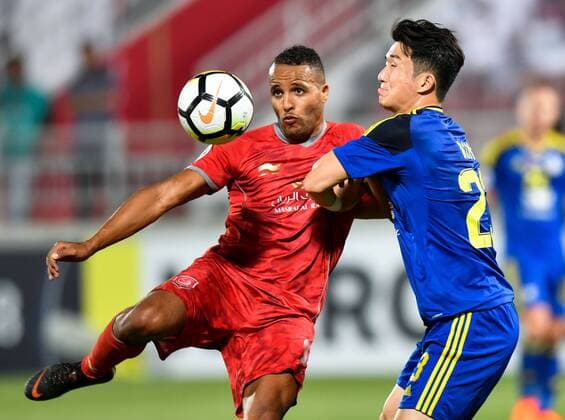 (180418) -- DOHA, April 18, 2018 -- Youssef El-Arabi (L) of Al Duhail SC vies for the ball with Rim Chang-Woo of Al Wahda FSCC during the AFC Champions League Group B soccer match between Qatar s AL Duhail SC and UAE s Al Wahda FSCC at Abdullah bin Khalifa Stadium in Doha, Qatar, April 17, 2018. Al Duhail won 1-0. ) (SP)QATAR-DOHA-SOCCER-AFC CHAMPIONS Nikku 