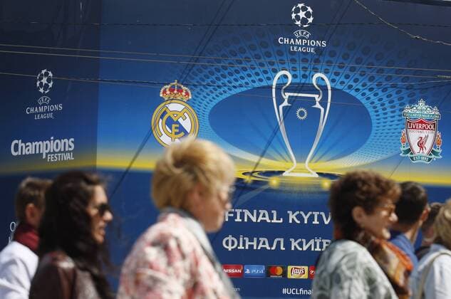 May 12, 2018 - Kiev, Ukraine - People walk pass a banner with the logo of the UEFA Champions League final in centr of Kiev, Ukraine, on 12 May 2018. Kiev will host the UEFA Champions League Final matches on 24 and 26 May 2018. UKRAINE UEFA CHAMPIONS LEAGUE FINAL 2018 - ZUMAg194 20180512_zap_g194_002 Copyright: xSergxGlovnyx