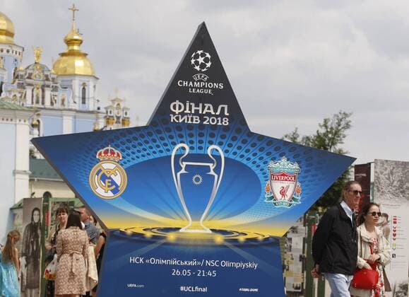 May 12, 2018 - Kiev, Ukraine - People walk pass an installation with the logo of the UEFA Champions League final in centr of Kiev, Ukraine, on 12 May 2018. Kiev will host the UEFA Champions League Final matches on 24 and 26 May 2018. UKRAINE UEFA CHAMPIONS LEAGUE FINAL 2018 - ZUMAg194 20180512_zap_g194_008 Copyright: xSergxGlovnyx
